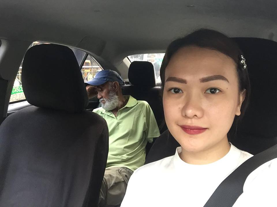 A woman passenger drives a taxi to relieve a sleepy 70-year old driver